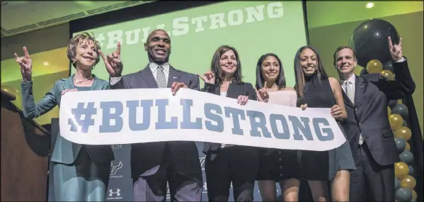  ?? ANDRES LEIVA / ASSOCIATED PRESS ?? Charlie Strong (second from left) is positioned to rebound quickly from his firing at Texas. He takes over a South Florida program that won 10 regular-season games this year and is a masterful recruiter within the Sunshine State.