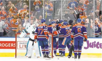  ?? JASON FRANSON/THE CANADIAN PRESS VIAAP ?? The Oilers celebrate a goal against Sharks goalie Martin Jones in the first period of Edmonton’s 3-2 win on Thursday in Edmonton, Alberta. The Sharks rallied late but fell short in the showdown.