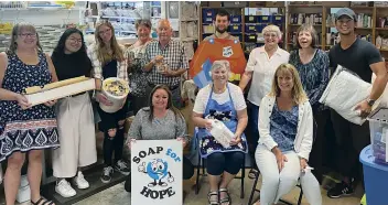  ??  ?? Clockwise from left: Tanaya Jilg holds a Soap for Hope sign as she poses with the team in Calgary; hygiene kit; laundry soap made from ground-up soap bars.