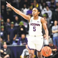  ?? Stephen Dunn / Associated Press ?? UConn’s Crystal Dangerfiel­d directs the Huskies during Wednesday night’s 82-38 win over Cincinnati in Storrs.