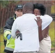  ?? Mark Wilson Getty Images ?? A WOMAN is consoled upon hearing of a tree falling on a Wilmington home and trapping three people inside. Two of the home’s inhabitant­s were killed.