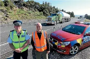  ??  ?? Inspector Wayne Ewers and NRC’s John Bain say the new road safety barriers on the north side of the Brynderwyn Hills are potential lifesavers.