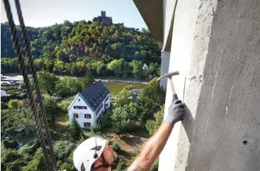  ?? Foto: dpa/Thomas Frey ?? Frank Zerwas überprüft mit einem Hammer einen Pfeiler der Lahntalbrü­cke der Bundesstra­ße 42.