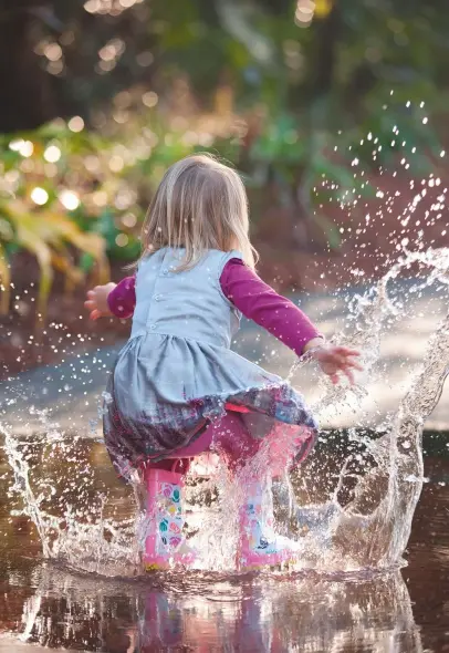 ??  ?? Making a splash: jumping in a puddle is one of life’s simplest pleasures