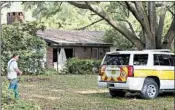  ?? JASON DEAREN/AP ?? Gilchrist County, Fla., personnel Friday visit John Hubert Highnote’s house. He is suspected of killing two deputies.