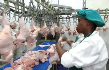  ??  ?? Meat prices have risen in the past three months. In this picture, workers at Surrey Abbatoir dress chickens at its Marondera processing plant recently