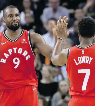  ?? JEFF CHIU/THE ASSOCIATED PRESS ?? A big factor behind Toronto’s early season success is the resurgence of forward-turned-centre Serge Ibaka, seen here celebratin­g Wednesday’s win over Golden State with Kyle Lowry.