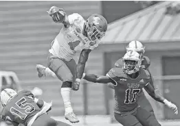  ?? Ronald Cortes / Contributo­r ?? Sam Houston State’s Ramon Jefferson leaps over Incarnate Word’s Shawn Holton. The Bearkats’ romp in their regular-season finale was a résumé boost.