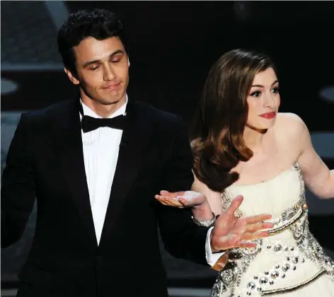  ?? GABRIEL BOuyS/GETTY IMAGES ?? Actors James Franco, left, and Anne Hathaway were roasted after hosting the Oscars together in 2011.