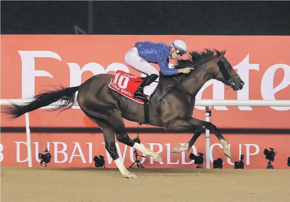  ?? Pawan Singh / The National ?? Christophe Soumillon and Thunder Snow crossed the finish line five-and-three-quarter lengths ahead of West Coast to win the Dubai World Cup