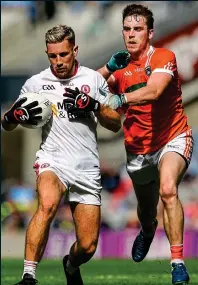  ??  ?? POWER: Niall Sludden (left) holds off Ciaran O’Hanlon