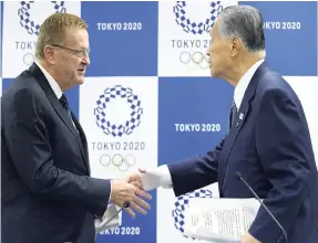  ??  ?? Internatio­nal Olympic Committee Vice-President John Coates (left) and Yoshiro Mori, president of the Tokyo Organising Committee of the Olympic and Paralympic Games, shake hands after their joint press conference in Tokyo yesterday.