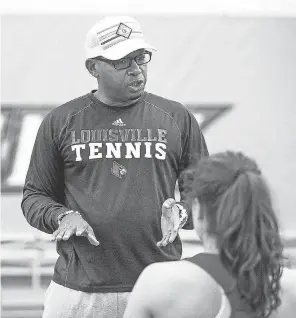  ??  ?? Louisville women’s tennis coach Mark Beckham talks to his team during a practice. He is the lone back head coach at the school.