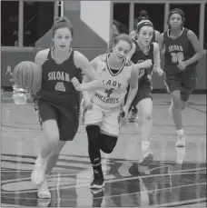  ?? Graham Thomas/Siloam Sunday ?? Siloam Springs senior Chloe Price steals the ball away from Springdale’s Alexa Bersi and goes the other way with it for a layup during Friday night’s game in the Siloam Springs Holiday Classic. Springdale defeated the Lady Panthers 56-37.