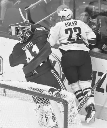  ?? ROSS D. FRANKLIN/ THE ASSOCIATED PRESS ?? Vancouver’s Alexander Edler, 23, bowls over Phoenix goalie Mike Smith on Thursday night, earning a five-minute charging penalty. He had a hearing Friday with the NHL’s department of player safety.