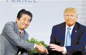  ?? Reuters-Yonhap ?? U.S. President Donald Trump and Japan’s Prime Minister Shinzo Abe shake hands at a bilateral meeting during the G7 summit in Biarritz, France in this Aug. 25 file photo.