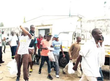  ??  ?? Some of the inmates freed under the recent Presidenti­al Amnesty, walk out of Harare Central Prison. — (Pictures by Tawanda Mudimu)