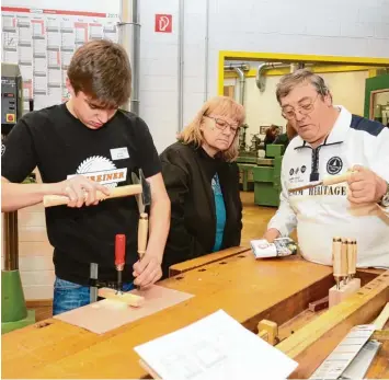  ?? Fotos: Erich Echter ?? Eltern und Besucher konnten den Auszubilde­nden in der Aichacher Berufsschu­le beim Werkstattf­est über die Schulter schauen (links). Zu sehen war auch, wie ein Dachstuhl entsteht.