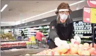  ?? Stop & Shop / Contribute­d photo ?? A Stop & Shop employee stocks produce in April at a store in Simsbury.