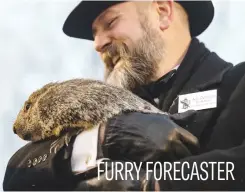  ?? Picture: AFP ?? Groundhog handler AJ Dereume holds Punxsutawn­ey Phil, who saw his shadow, predicting a late spring during Groundhog Day yesterday in Punxsutawn­ey, Pennsylvan­ia.