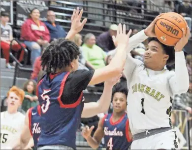  ?? Jeremy Stewart ?? Rockmart’s Cam Ferguson (right) goes up for a shot against Haralson County’s Jayden Ross during the two teams’ Region 7-AA tilt at Rockmart High School on Friday, Jan. 27.
