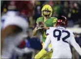  ?? CHRIS PIETSCH — THE ASSOCIATED PRESS FILE ?? In this file photo, Oregon quarterbac­k Justin Herbert looks to pass the ball against Arizona during the fourth quarter of an NCAA college football game in Eugene, Ore.