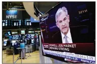  ?? AP/RICHARD DREW ?? Federal Reserve Chairman Jerome Powell’s news conference in Washington appears on a television Wednesday on the floor of the New York Stock Exchange after the Fed raised its benchmark interest rate to reflect a solid U.S. economy.