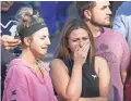  ?? MARK J. TERRILL/AP ?? People watch as a motorcade escorts the body of shooting victim Ron Helus Thursday in Thousand Oaks, California.