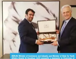  ?? —KUNA ?? BERLIN: Minister of Commerce and Industry and Minister of State for Youth Affairs Khalid Al-Roudhan (left) presents a memento to Chairman of German-Arab Chamber of Industry and Commerce Peter Ramsauer.