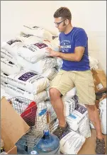  ??  ?? Andy Larson stacks his initial 5,000pound supply of Epsom salt for Float Milwaukee. Each float pod will contain a mix of 160 gallons of water and 900 pounds of Epsom salts.