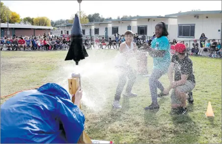  ?? Nikolas Samuels
/The Signal ?? Patrick Falliaux, left, and Ricquel Ford pull a string causing their bottle rocket to launch at Santa Clarita Elementary School in Saugus on Friday. The fun experiment was a part of the school’s Next Generation Science Standards. Students were put into...