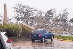  ?? EDWIN PROPST/ASSOCIATED PRESS ?? Winds on the island of Saipan howl as Super Typhoon Yutu swept through the Commonweal­th of the Northern Mariana Islands earlier in the week. The storm injured several people.
