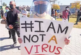  ?? RINGO CHIU/AFP VIA GETTY IMAGES ?? Tracy Wong takes part in a Feb. 20 rally near Chinatown in Los Angeles, Calif., to raise awareness of anti-Asian violence.