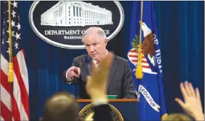  ?? The Associated Press ?? Attorney General Jeff Sessions calls on a reporter during a news conference at the Justice Department in Washington on Thursday. Sessions said he will recuse himself from a federal investigat­ion into Russian interferen­ce in the 2016 election.