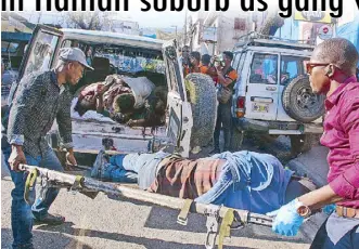  ?? AFP ?? Paramedics carry the body of a person killed by street gangs in Pétion-Ville, Port-au-Prince, Haiti on Monday.