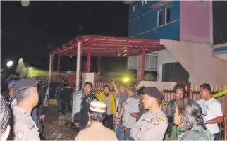  ?? — AP ?? BEKASI: Officers stand guard around a house after it was raided by police.