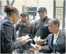  ?? Picture: IHSAAN HAFFEJEE ?? NO FLIGHT: SA Express staff hand out boarding passes for alternativ­e flights to stranded passengers including DJ Mobi Dixon (centre) who was due to perform in Kimberley last night