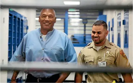  ?? PHOTO: REUTERS ?? OJ Simpson is escorted by a correction­s officer as he arrives for his parole hearing at Lovelock Correction­al Centre in Lovelock, Nevada.