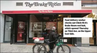  ?? ?? Food delivery worker checks out Chick-fil-A’s Brake Room rest hub, which opened Thursday on Third Ave. on the Upper East Side.