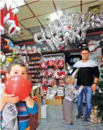  ?? Reuters ?? A Palestinia­n boy blows up a balloon in a shop selling Christmas gifts in Bethlehem in the occupied West Bank on Wednesday.