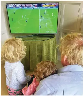  ?? ?? Family viewing: PM Boris Johnson watches with Wilf and Romy