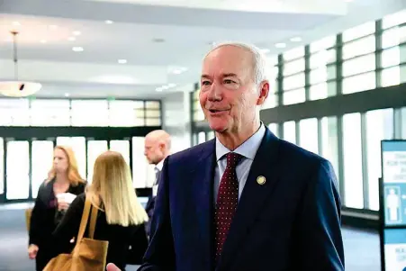  ?? The Sentinel-Record/Tanner Newton ?? ■ Gov. Asa Hutchinson speaks to the media Wednesday at the Arkansas Connectivi­ty Summit in the lobby of the Hot Springs Convention Center.