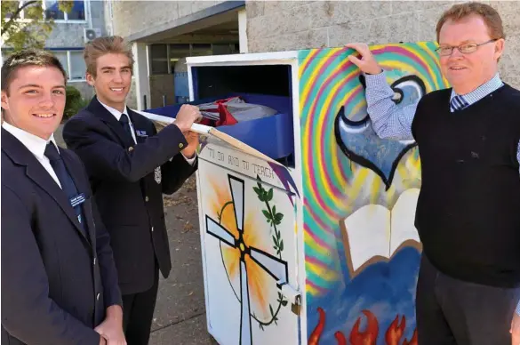  ??  ?? GOOD DEED: St Mary’s College students Heath Dean (left) and Kyle Betros and principal Michael Newman with a brightly Vinnies donation bin, which is part of a new initiative with many schools in Toowoomba. PHOTO: KEVIN FARMER