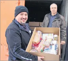  ?? GREG MCNEIL/SALTWIRE NETWORK ?? Daniel Lowther, district operator for Sobeys Cape Breton region, left, displays a portion of the Christmas dinner former ServiCom employees received last week at the Salvation Army offices in Sydney. Sobeys employees put the donation together through an internal ‘random acts of kindness’ that grew and grew.