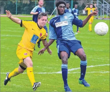  ?? Picture: Alan Coomes ?? K Sports’ Caine Smith, left, closes down Lewisham on Saturday