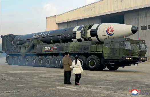  ?? AP ?? North Korean leader Kim Jong Un, left, and his daughter inspect what Pyongyang says is a Hwasong-17 interconti­nental ballistic missile at Pyongyang Internatio­nal Airport.