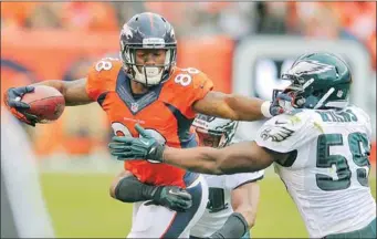  ?? THE ASSOCIATED PRESS ?? Denver Broncos wide receiver Demaryius Thomas (88) stiff arms Philadelph­ia Eagles inside linebacker DeMeco Ryans (59) in the fourth quarter of an NFL football game on Sunday in Denver.