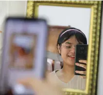  ?? (Lim Huey Teng/Reuters) ?? MALAYSIAN TEENAGER Ain Husniza Saiful Nizam takes video for her TikTok page in her bedroom in Kuala Selangor.