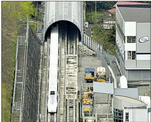  ?? AP ?? A train for Japan’s magnetic-levitation railway runs on a test line in Tsuru, Japan, in this file photo. Prosecutor­s are looking into the possibilit­y that bids were rigged for part of the multibilli­on-dollar project.