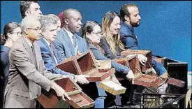  ?? AFP ?? UN conference officers hold up empty ballot boxes before collecting ballots from delegates at the election of new members of the UN Human Rights Council on Oct. 12 at the UN in New York. Top photo shows a general view of the opening day of the 39th UN Council of Human Rights at the UN offices in Geneva earlier this year.